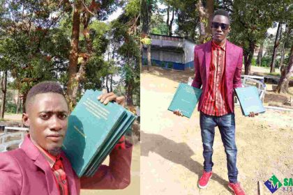 N'jala Student Celebrates as He Shows off Copies of His Dissertation