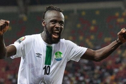 Kei Kamara celebrates after scoring a goal for Sierra Leone’s Leone Stars, raising his hands to the sky while wearing the Green, White and Blue national team jersey